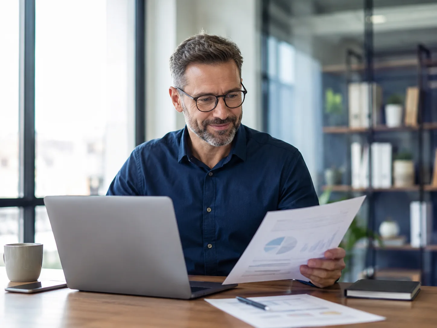 Small business leader reviewing a clear cybersecurity readiness report with confidence